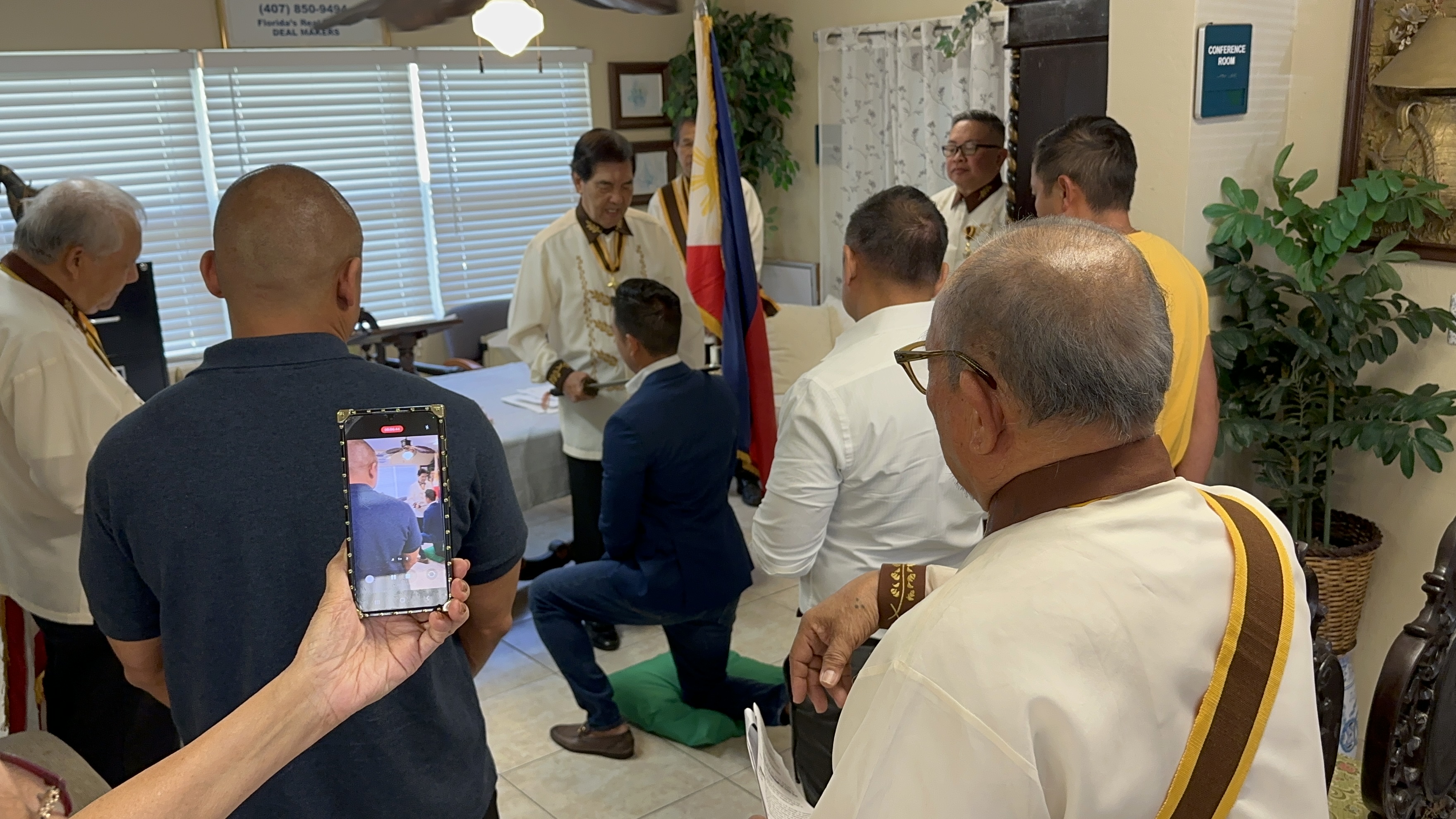 KOR induction ceremony with sword and Philippine flag