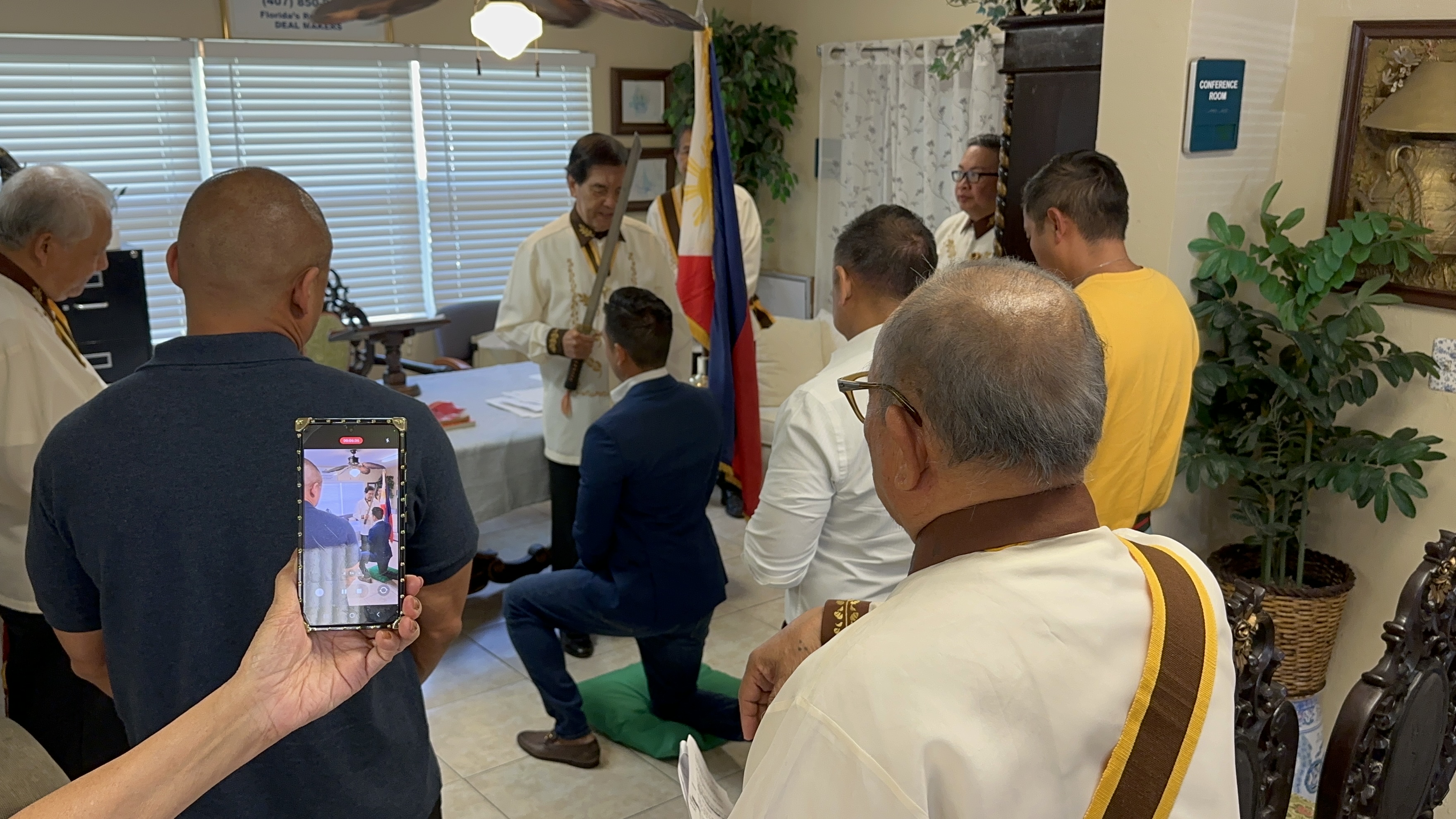 Knight being inducted with ceremonial sword