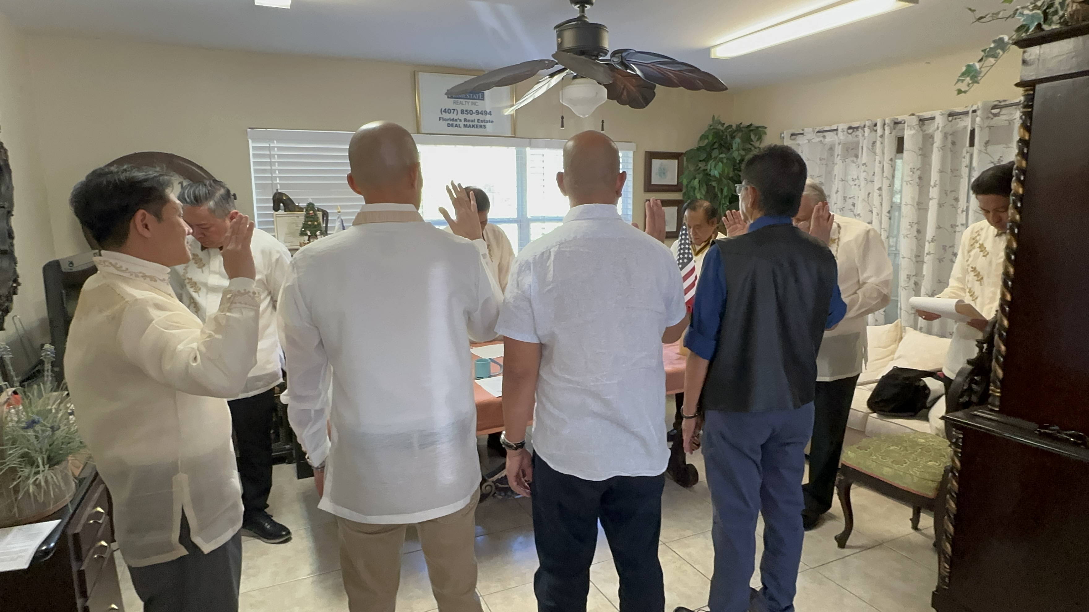 Group oath-taking ceremony with hands raised